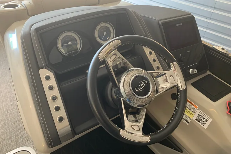 Slide: The Image of 2022 Barletta LUSSO 25U boat dashboard with steering wheel and control panel. - 10
