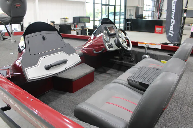 Slide: The Image of 2016 Ranger RT188 boat interior with dual consoles and gray seating in showroom. - 14