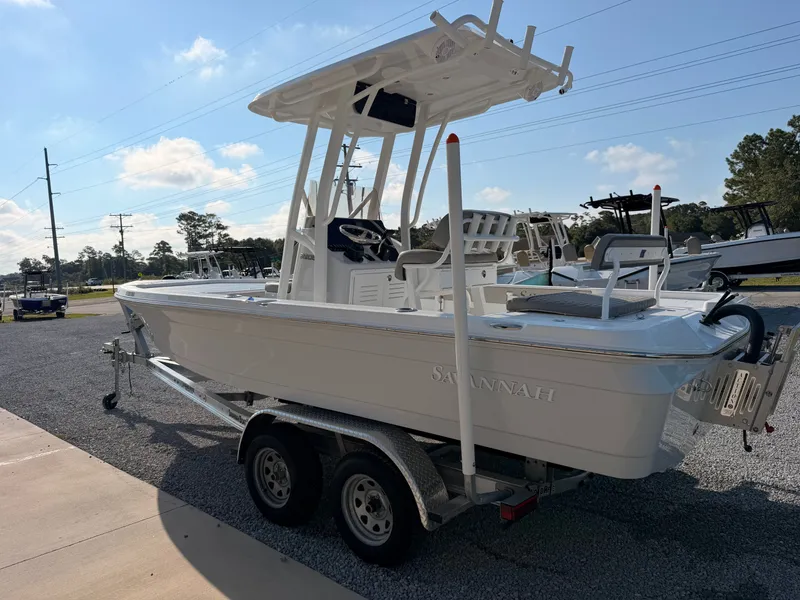Slide: The Image of A white 2027 Savannah 220 IS boat on a trailer in a parking lot. - 3