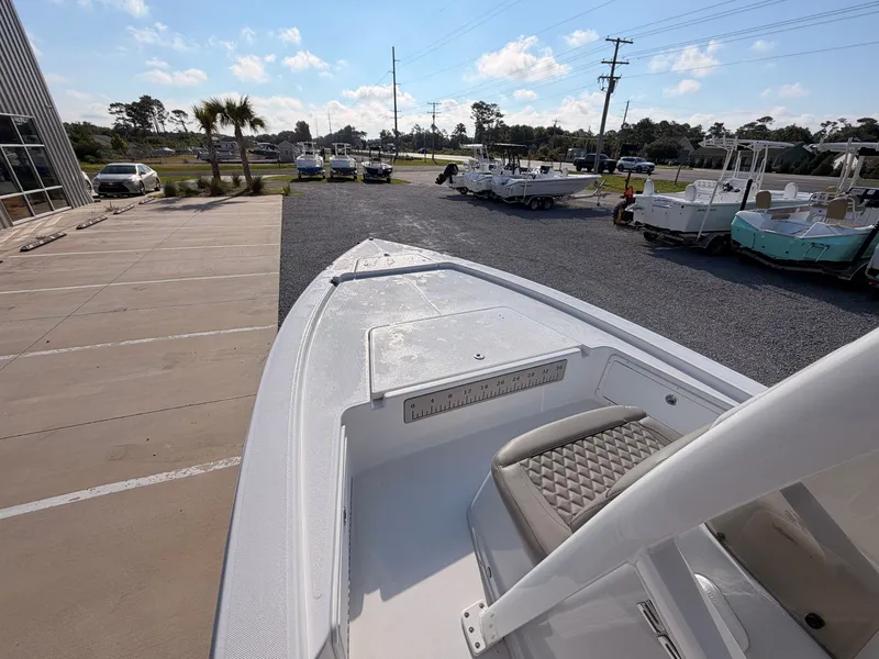 Slide: The Image of A 2027 Savannah 220 IS boat is parked on a lot. It features a sleek, modern design. - 9