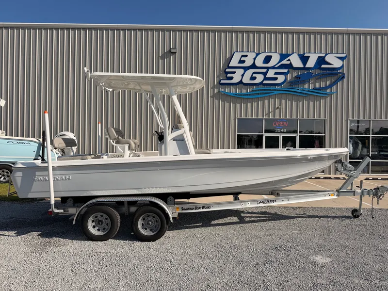 The Image of A 2027 Savannah 220 IS boat on a trailer outside a boat dealership. - 0