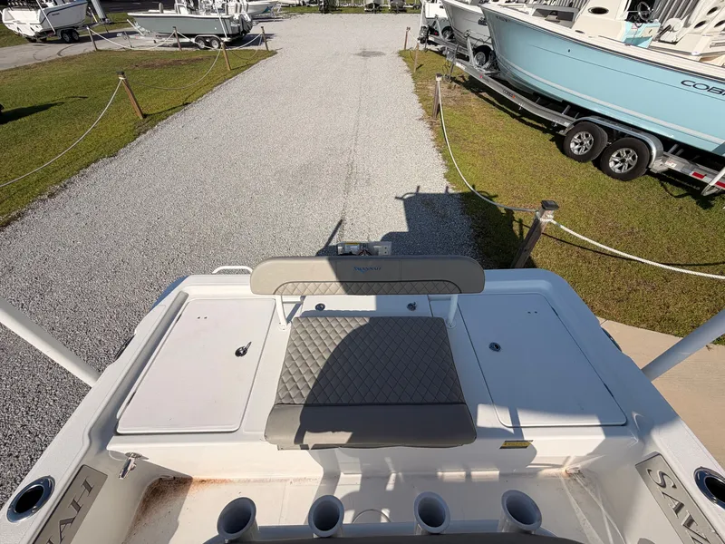 Slide: The Image of The image shows the stern of a 2027 Savannah 220 IS boat with seating and rod holders. - 13