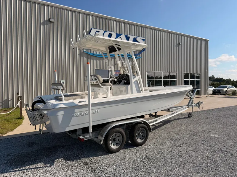 Slide: The Image of A 2027 Savannah 220 IS boat on a trailer in front of a building. - 1