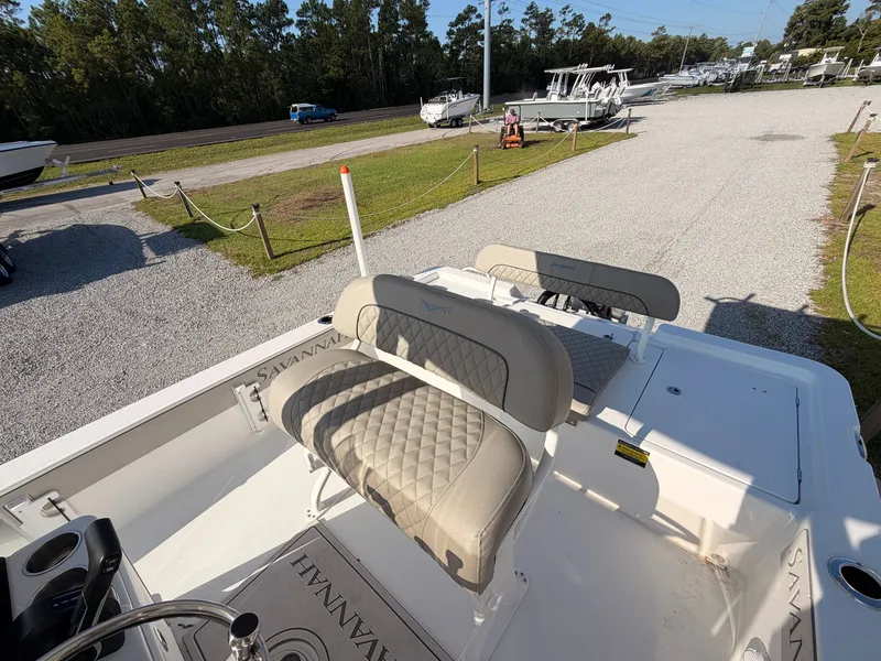 Slide: The Image of The image shows the cockpit of a 2027 Savannah 220 IS boat with cushioned seats. - 12