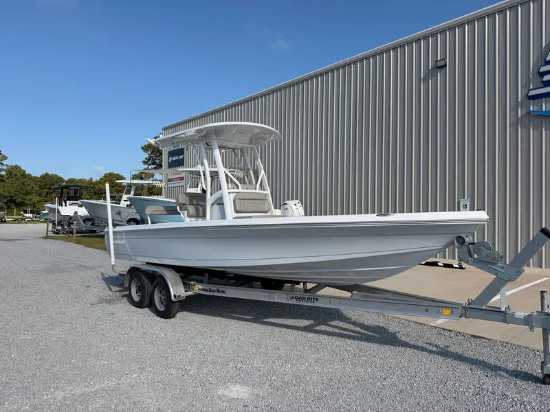 Slide: The Image of A 2027 Savannah 220 IS boat on a trailer in front of a building. - 7