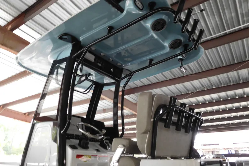 Slide: The Image of 2026 Sea Hunt BX25FS boat interior with T-top and rod holders under a metal roof. - 2