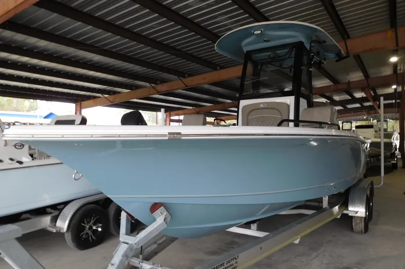Slide: The Image of 2026 Sea Hunt BX25FS boat in a covered storage area, showcasing sleek design and modern features. - 3
