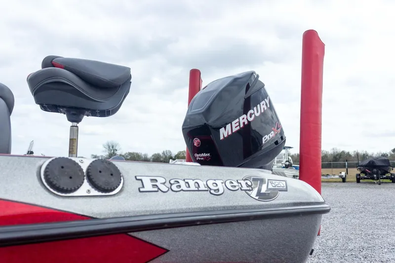 Slide: The Image of 2009 Ranger Z520 Comanche boat with Mercury Pro XS engine, parked outdoors. - 13