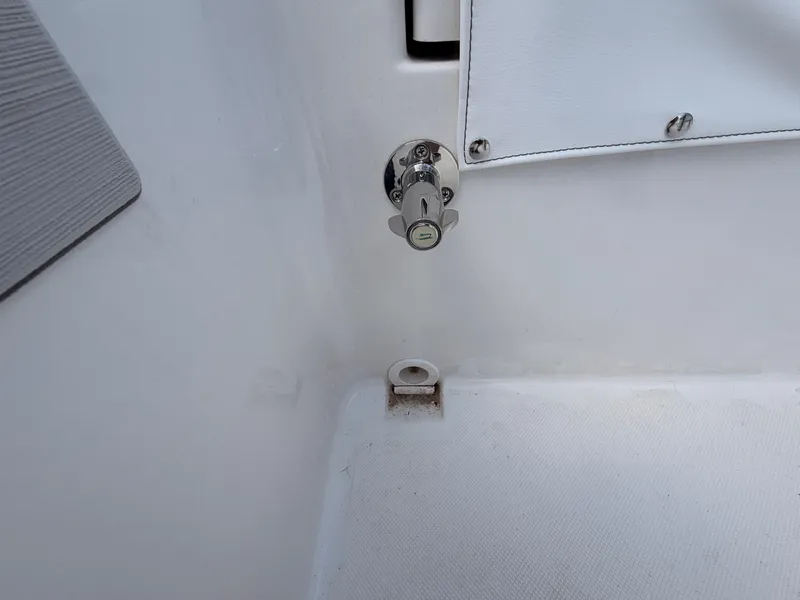 Slide: The Image of Close-up of a white boat deck with a metal latch and a cover. - 15