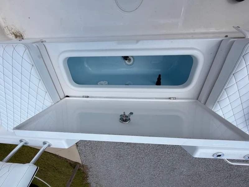 Slide: The Image of The image shows a white boat with an open storage compartment and cushioned seats. - 14