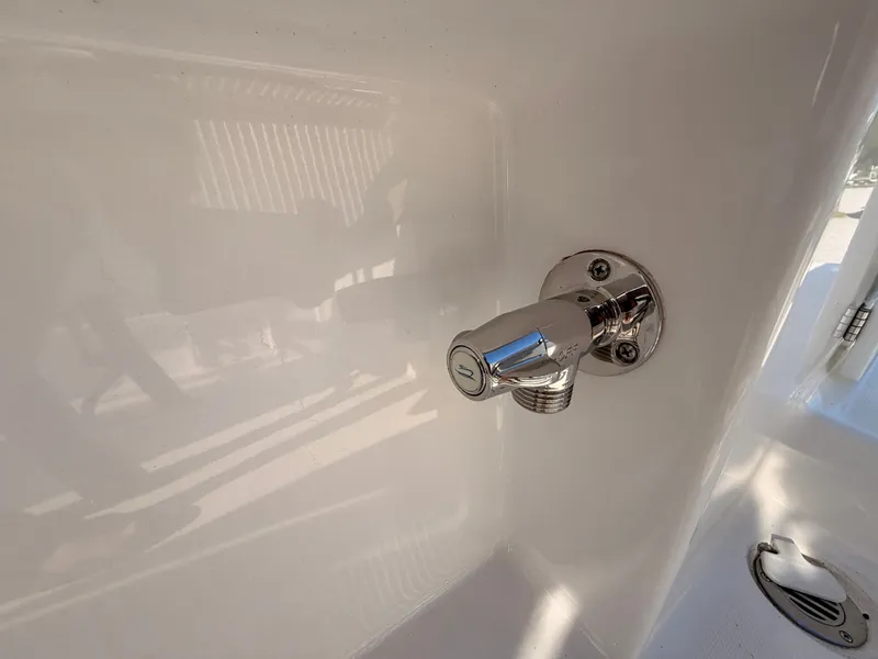 Slide: The Image of Close-up of a shiny faucet on a boat, surrounded by white material. - 14