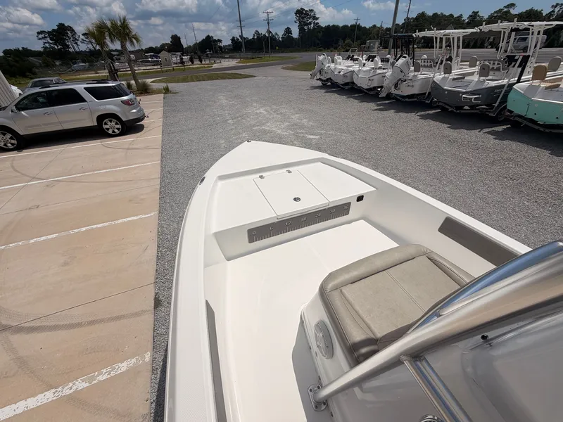 Slide: The Image of The image shows the deck of a 2027 Savannah 190 IS boat parked on a gravel lot. - 10