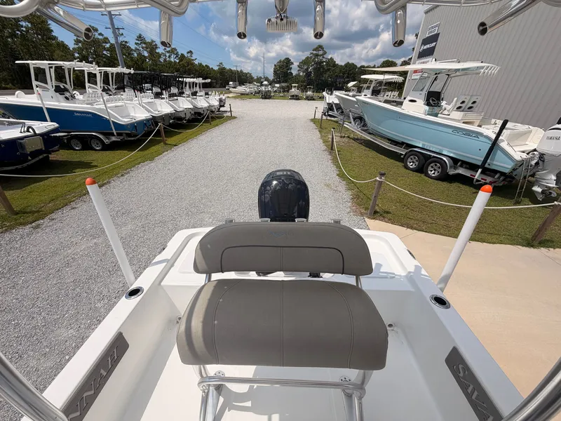 Slide: The Image of View from the stern of a Savannah 190 IS boat overlooking a boatyard with several boats. - 13