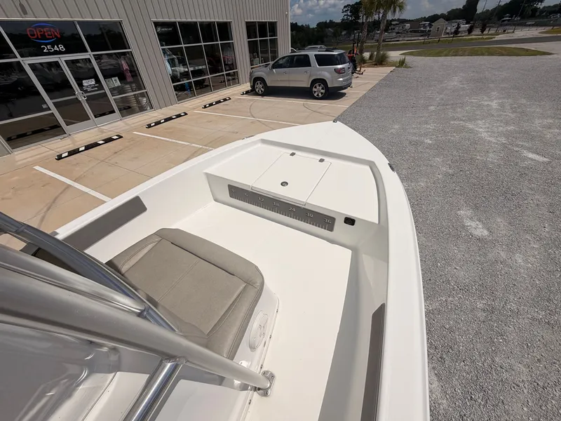 Slide: The Image of The image shows the bow of a 2027 Savannah 190 IS boat parked in front of a building. - 11