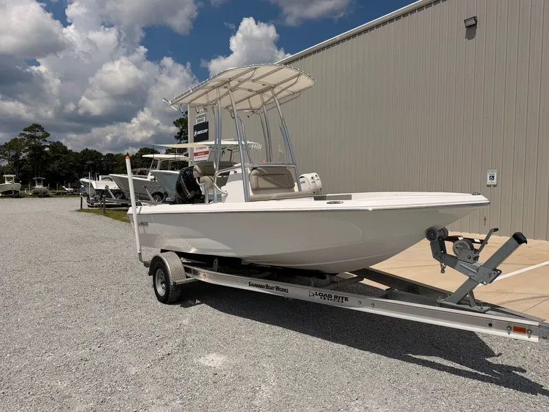 Slide: The Image of A 2027 Savannah 190 IS boat on a trailer in front of a building. - 7
