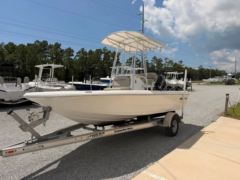 Slide: The Image of A 2027 Savannah 190 IS boat on a trailer in a gravel lot. - 5