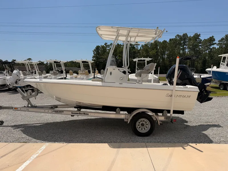 Slide: The Image of A 2027 Savannah 190 IS boat on a trailer, featuring a T-top and outboard motor. - 4