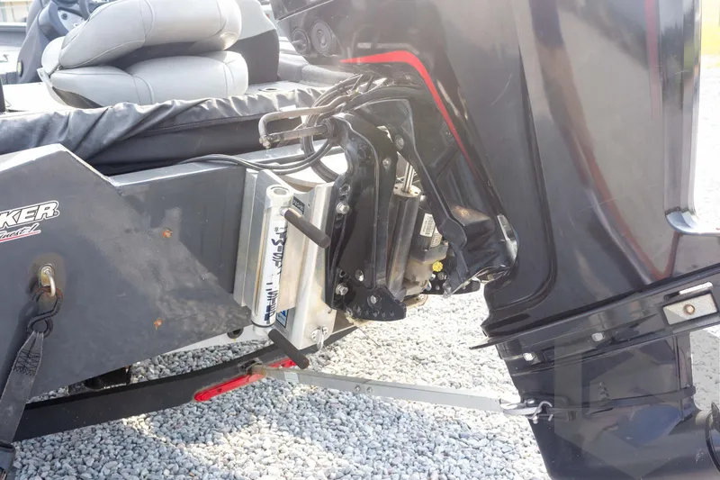 Slide: The Image of 2019 Tracker Pro Team 190 TX boat motor and transom detail on gravel surface. - 14
