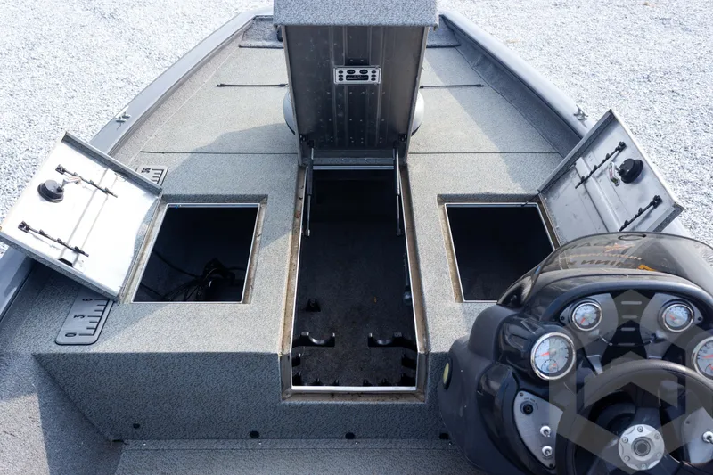 Slide: The Image of 2019 Tracker Pro Team 190 TX boat interior with open storage compartments and control panel. - 17