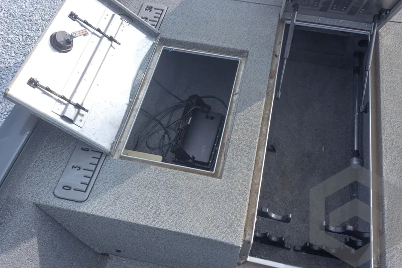 Slide: The Image of 2019 Tracker Pro Team 190 TX boat storage compartments with measuring scale and wiring. - 18