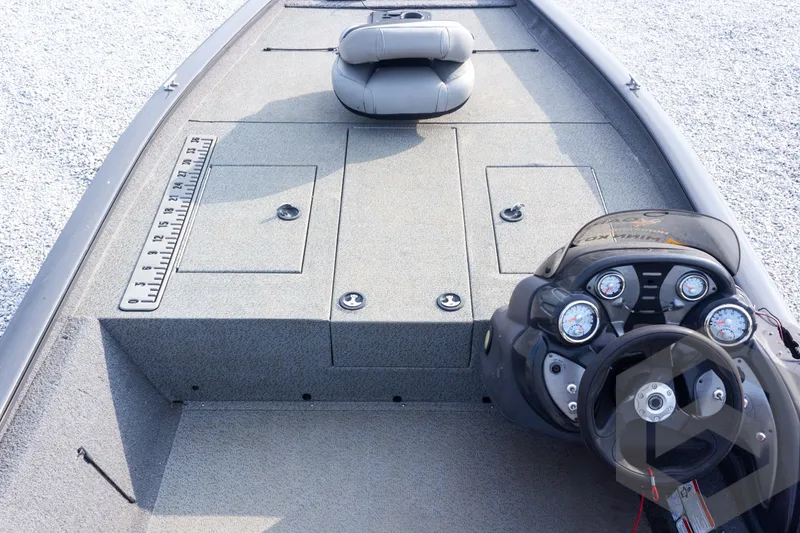 Slide: The Image of 2019 Tracker Pro Team 190 TX boat interior with steering console and storage compartments. - 16