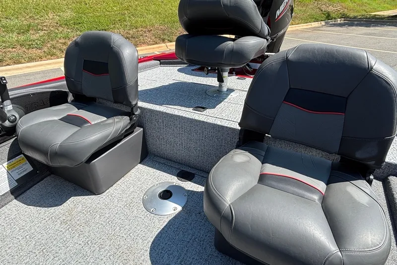 Slide: The Image of 2024 Tracker Pro Team 175 TF boat seats, gray upholstery, outdoor setting. - 16