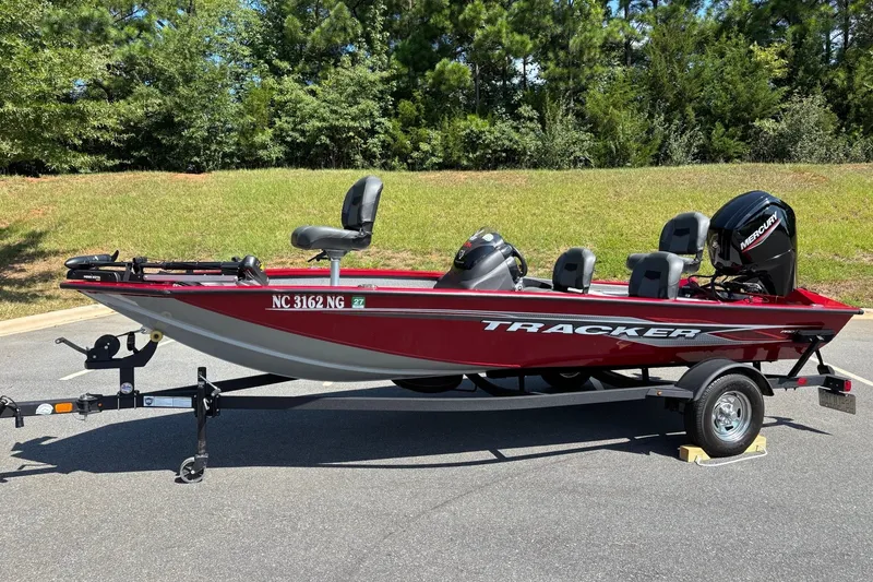 The Image of 2024 Tracker Pro Team 175 TF fishing boat on trailer, parked outdoors. - 0