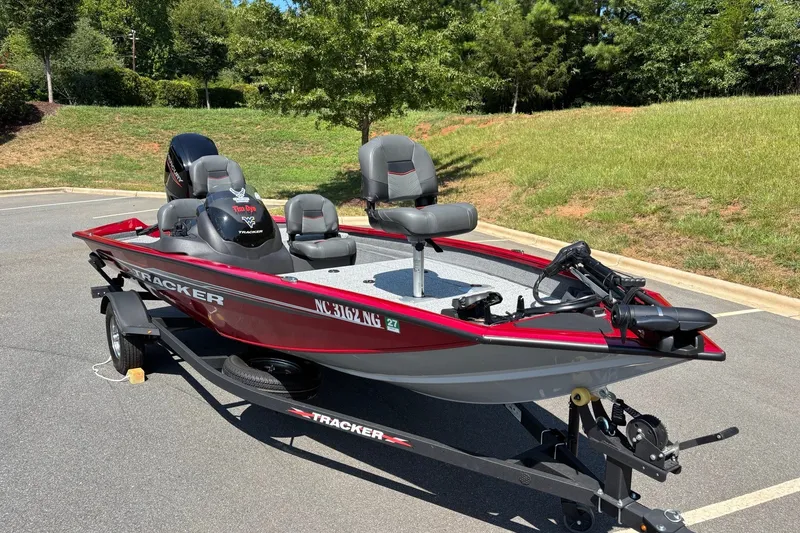 Slide: The Image of 2024 Tracker Pro Team 175 TF fishing boat on trailer, parked outdoors. - 14
