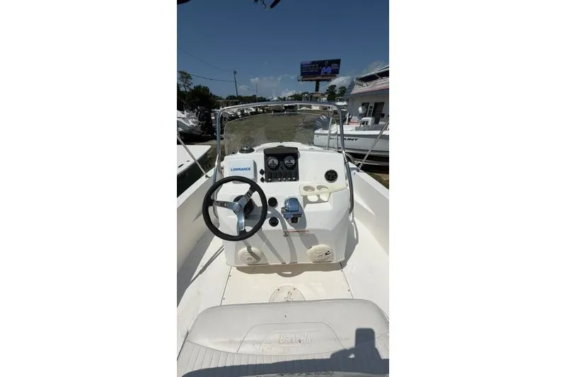 Slide: The Image of 2008 Boston Whaler 180 Dauntless boat console with steering wheel and navigation equipment. - 18