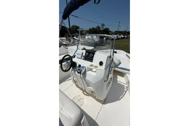 Slide: The Image of 2008 Boston Whaler 180 Dauntless boat console with steering wheel and controls. - 25