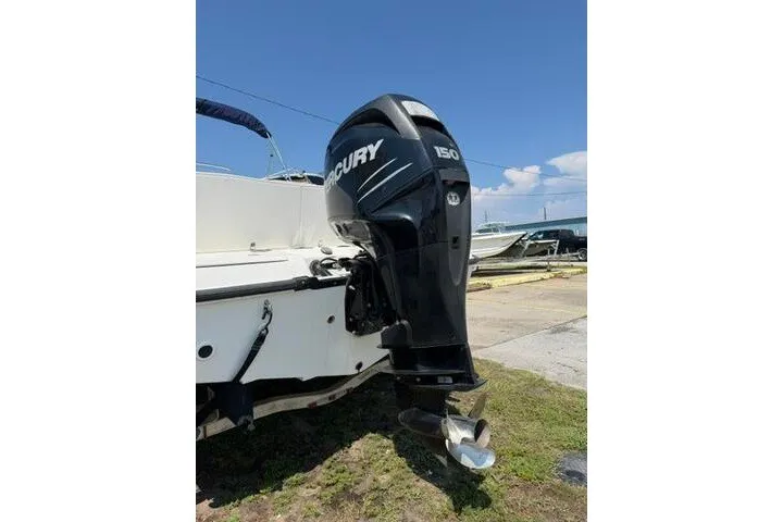 Slide: The Image of 2008 Boston Whaler 180 Dauntless with Mercury 150 outboard motor, parked outdoors. - 7