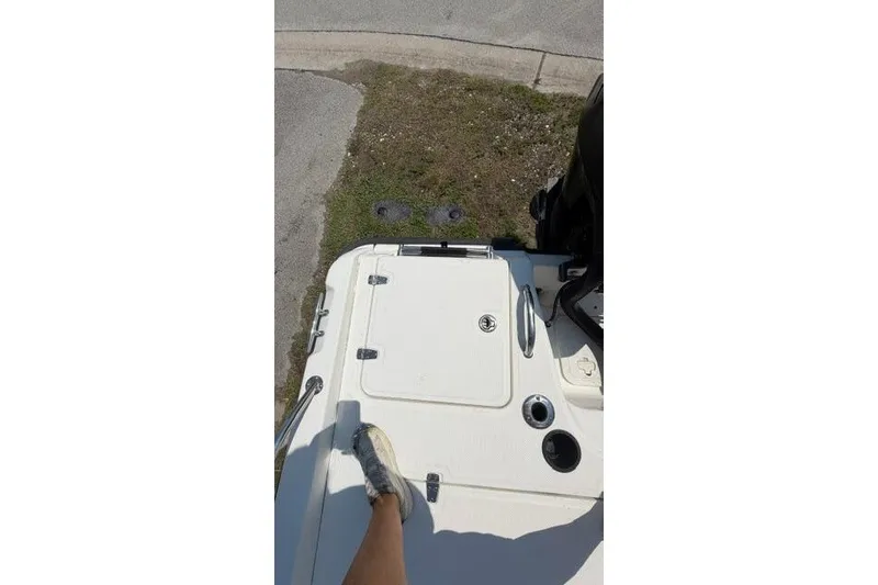 Slide: The Image of 2008 Boston Whaler 180 Dauntless boat deck with storage compartment and foot visible. - 17