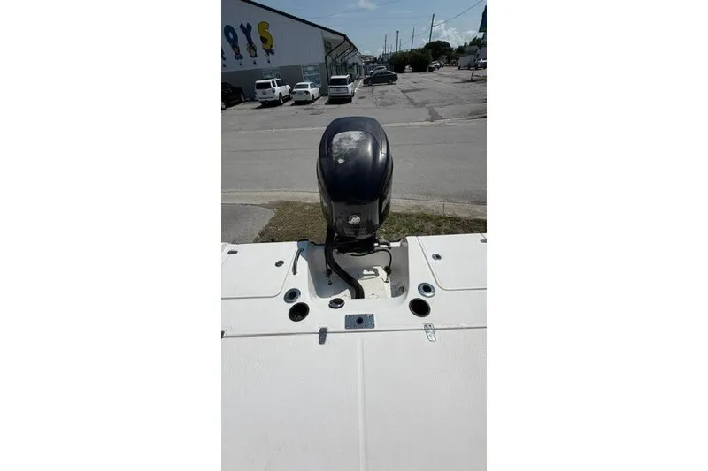 Slide: The Image of 2008 Boston Whaler 180 Dauntless boat with outboard motor in a parking lot. - 16