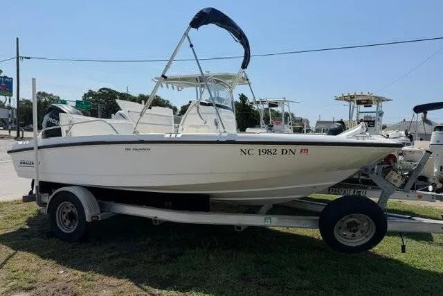 The Image of 2008 Boston Whaler 180 Dauntless boat on trailer, parked outdoors. - 0