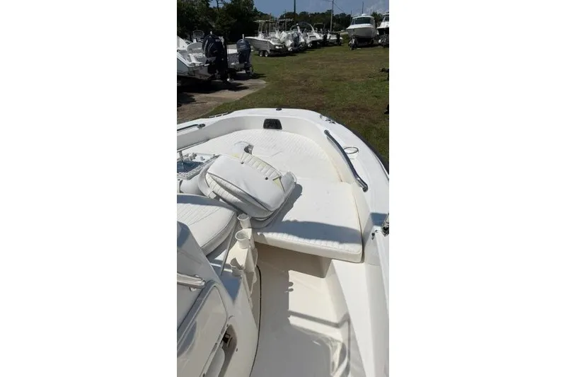 Slide: The Image of 2008 Boston Whaler 180 Dauntless boat interior with white seating and storage compartments. - 24