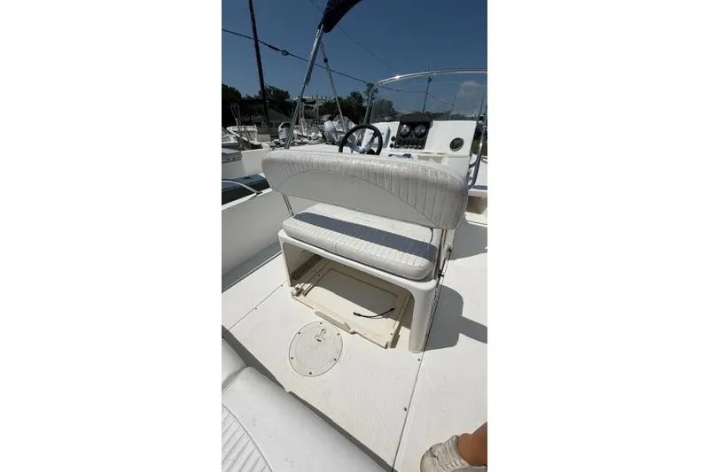 Slide: The Image of 2008 Boston Whaler 180 Dauntless boat interior with white seating and steering console. - 26