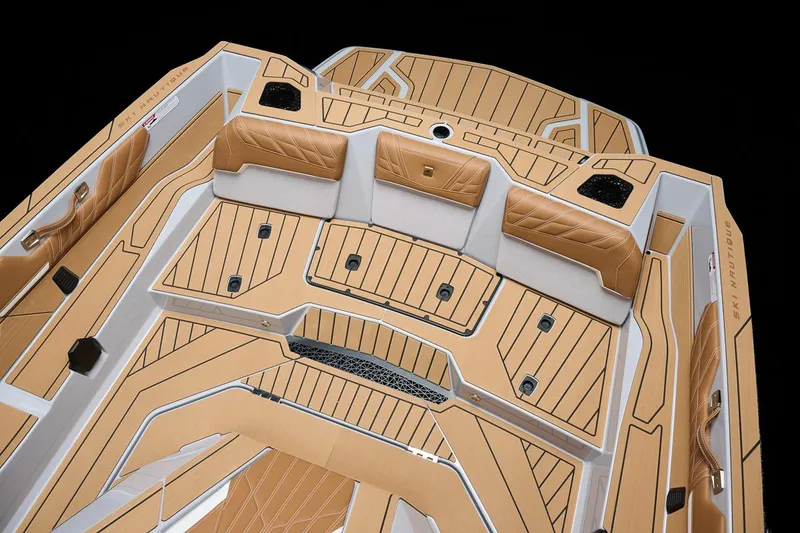 Slide: The Image of Manufacturer Provided Image: 2026 Nautique Ski Nautique boat interior with tan and white upholstery, featuring sleek design and seating. - 13