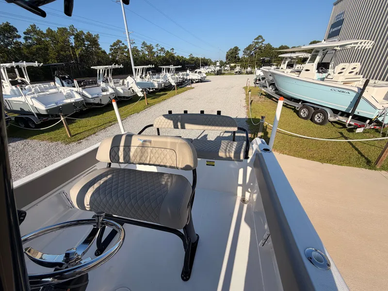 Slide: The Image of The image shows the deck of a 2027 Savannah 2200 Offshore boat with cushioned seats. - 14