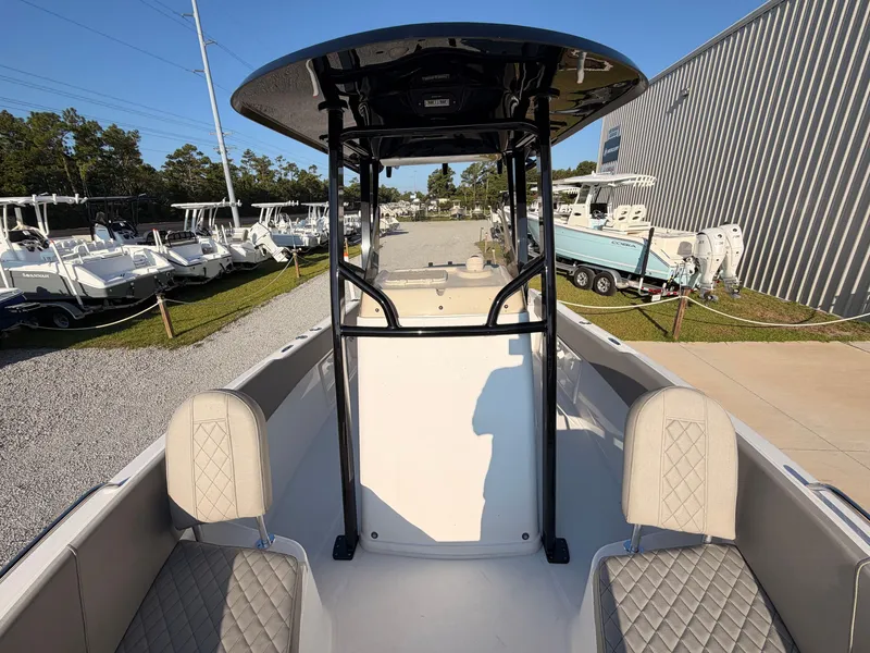 Slide: The Image of The image shows the cockpit of a 2027 Savannah 2200 Offshore boat with cushioned seats. - 13