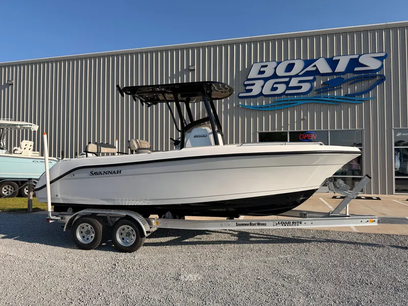 The Image of A 2027 Savannah 2200 Offshore boat on a trailer outside a boat dealership. - 0