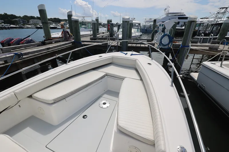 Slide: The Image of 1999 Regulator 26 Forward Seating boat docked at marina, showcasing spacious seating area. - 35