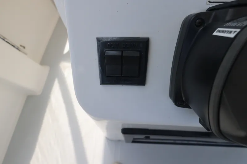Slide: The Image of Close-up of a control panel with two switches and a black knob. - 22