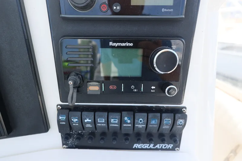 Slide: The Image of Control panel of a 1999 Regulator 26 Forward Seating boat with Raymarine equipment. - 19