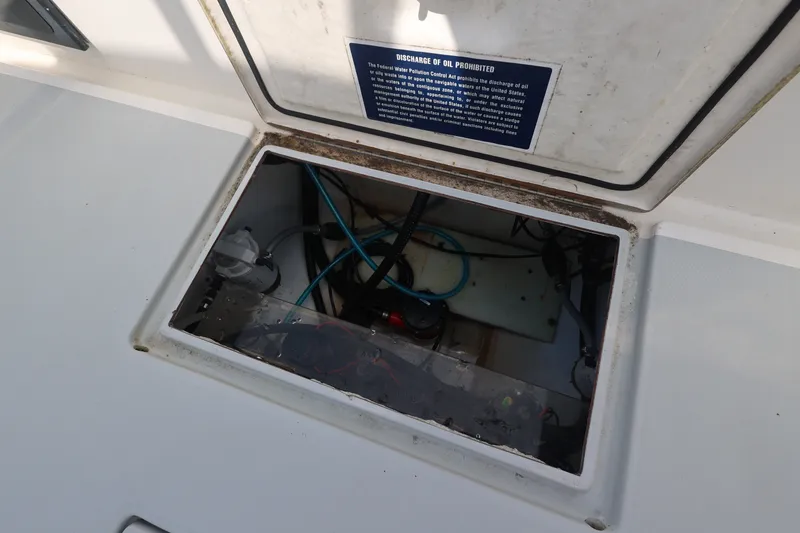 Slide: The Image of Open hatch on 1999 Regulator 26 Forward Seating boat, showing internal wiring and components. - 26
