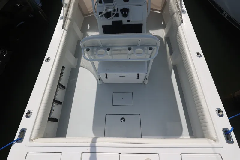 Slide: The Image of 1999 Regulator 26 Forward Seating boat interior with helm and seating area. - 15