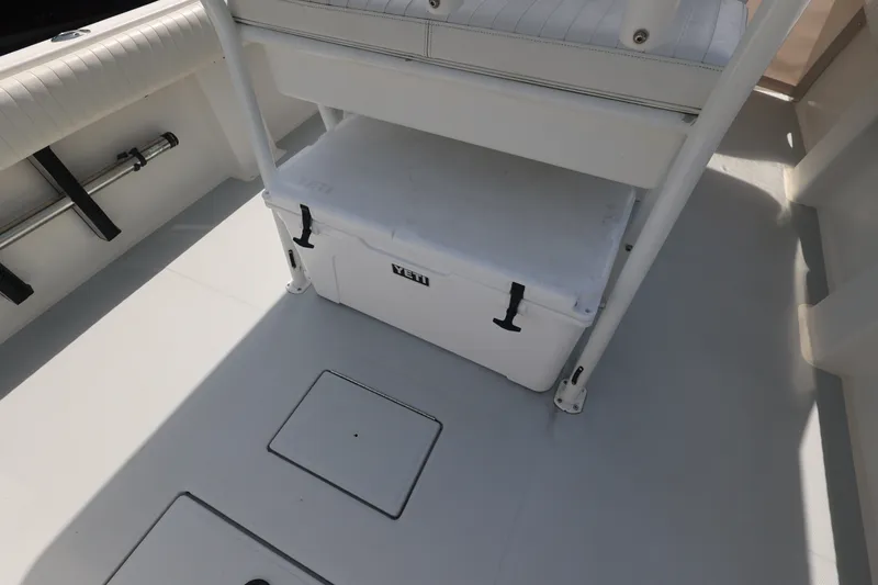 Slide: The Image of 1999 Regulator 26 Forward Seating boat interior with Yeti cooler storage. - 27