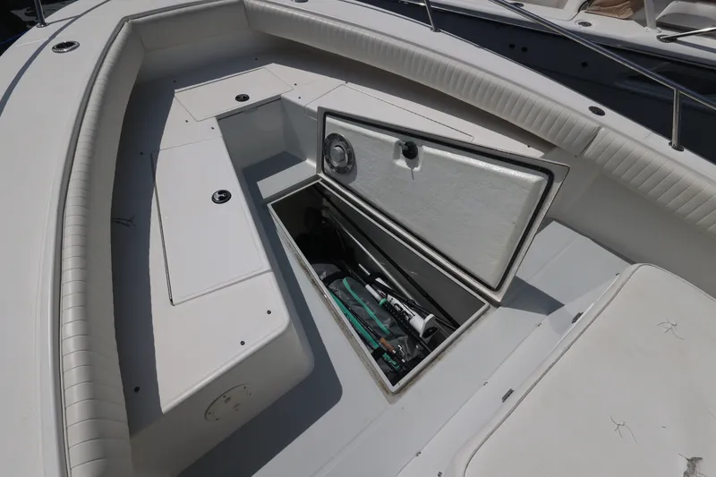 Slide: The Image of The image shows the bow area of a Regulator 26 Forward Seating boat with storage space. - 31