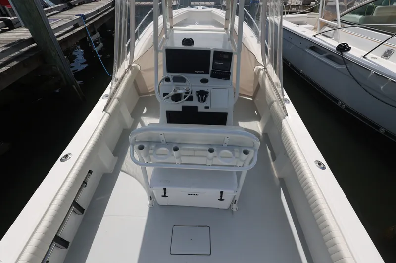Slide: The Image of 1999 Regulator 26 Forward Seating boat interior with helm and seating area. - 14