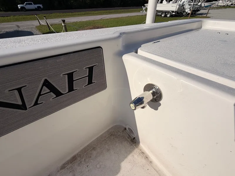 Slide: The Image of Close-up of a white boat deck with a silver faucet and nameplate. - 14