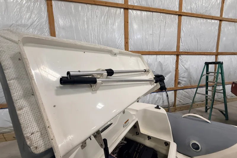 Slide: The Image of 2013 Zodiac Yachtline 2 Deluxe 340 boat interior with open storage compartment in a garage. - 10